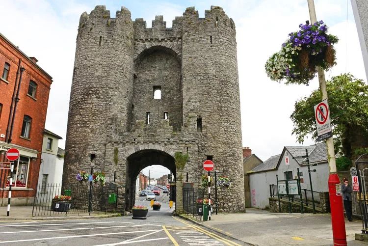 St Laurence’s Gate in Drogheda, a medieval stone barbican with twin drum towers framing a pointed archway over the street.