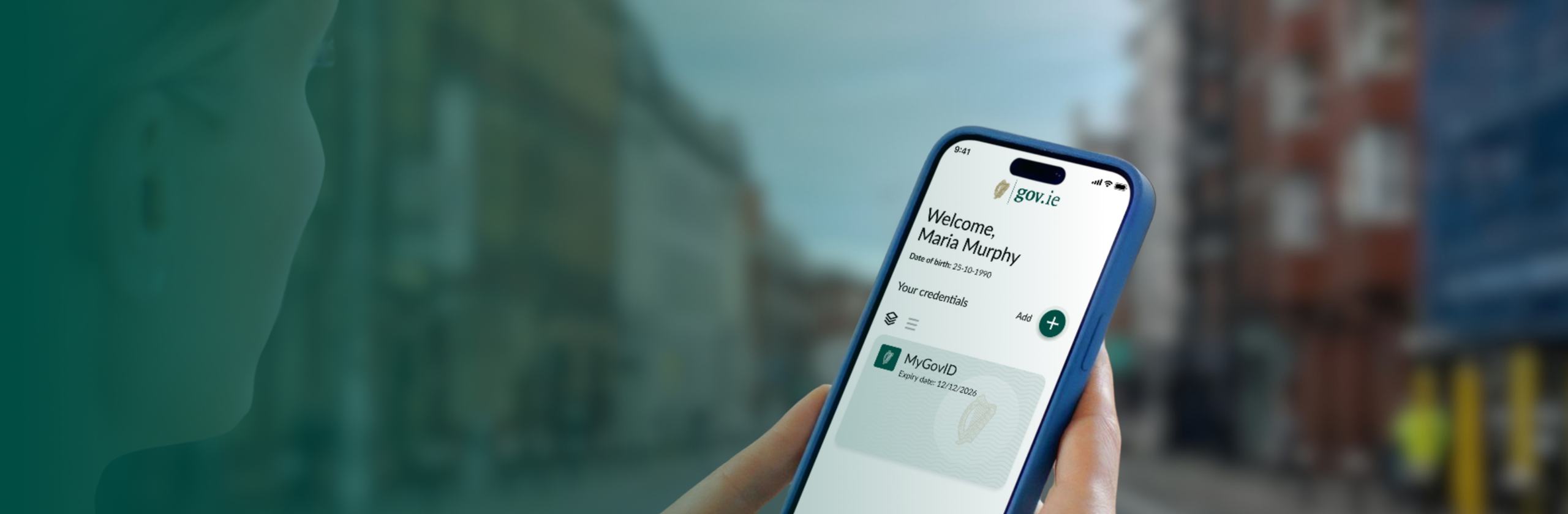 Hand holding a phone showing the gov.ie Government Digital Wallet with a MyGovID credential